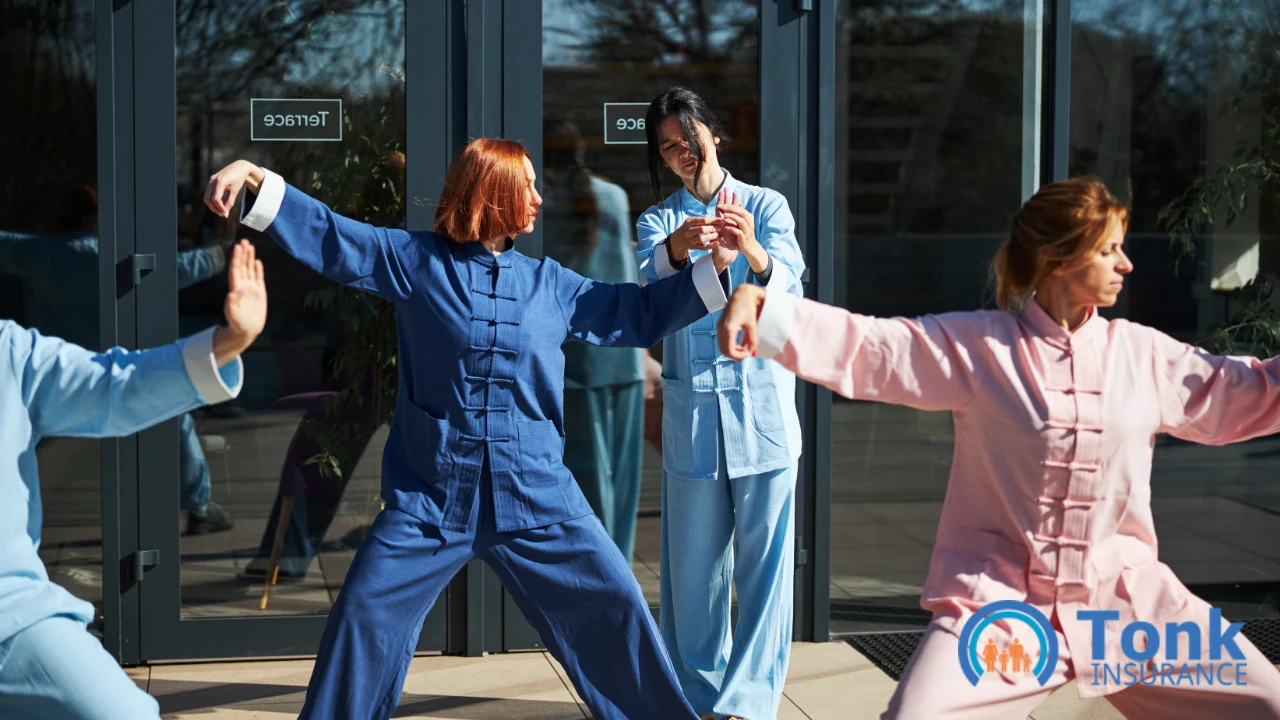 Tai chi instructor correcting a student's posture during an outdoor group class